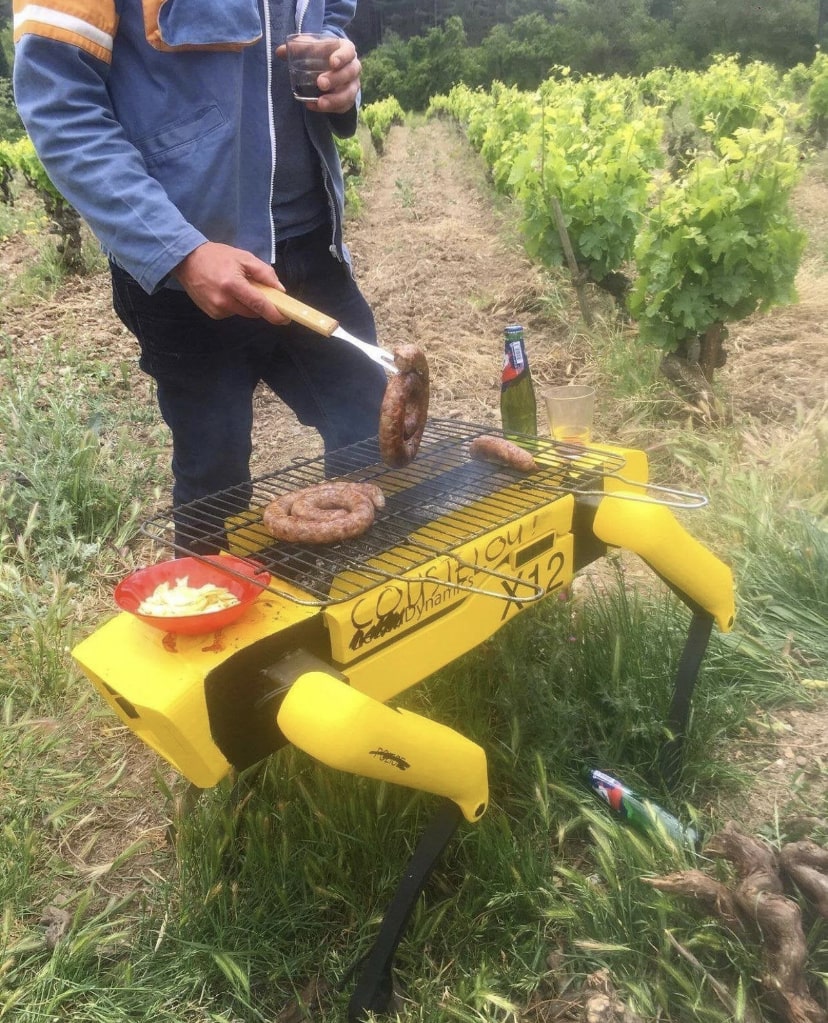Someone grilling sausages in the top part of what looks like a Boston Dynamics Spot robot.