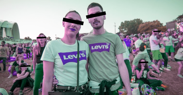 A couple posing for a picture, wearing a Levis shirt.
